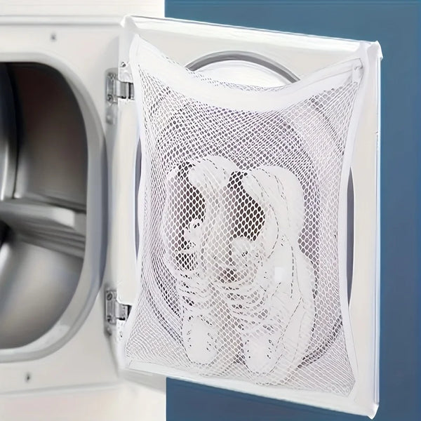A white mesh bag for washing shoes is shown inside an open appliance compartment.