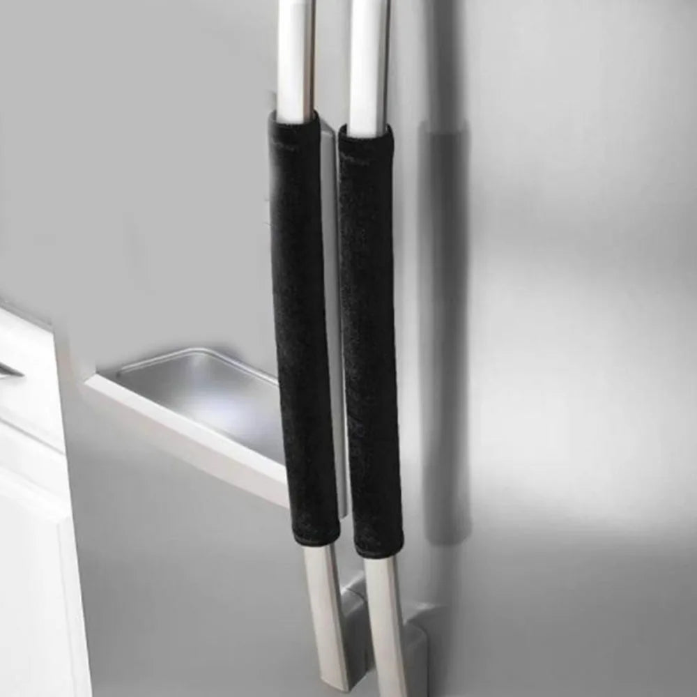 Two black oil-proof refrigerator handle covers hanging on a silver metal rack.