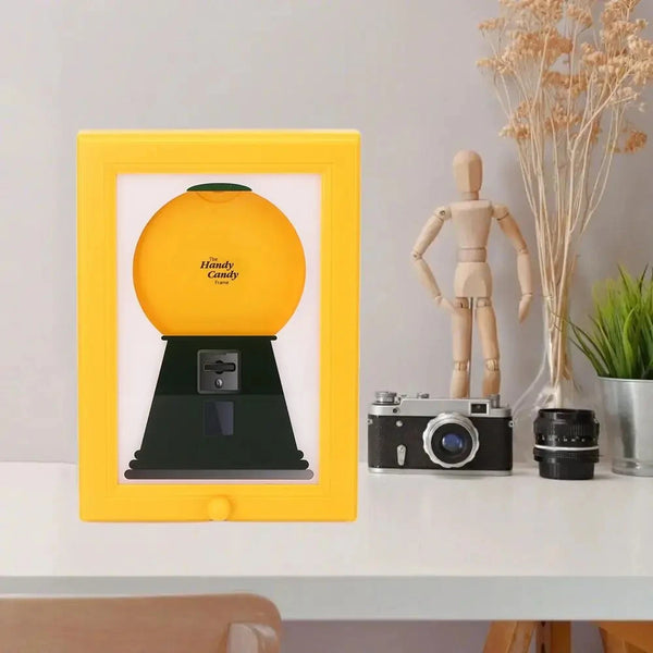 A yellow frame displays a vintage candy-themed object, including a figurine and a camera.