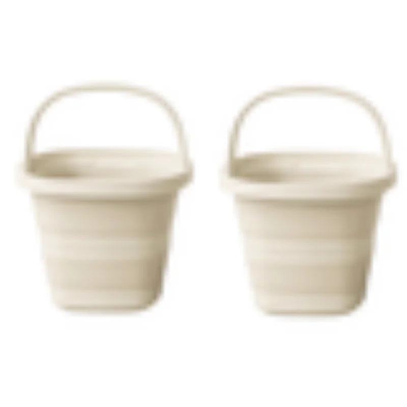 A pair of beige collapsible water buckets with handles for portable storage.