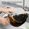 Hands are cleaning a dark pot with a double-sided concave friction cleaner tool.