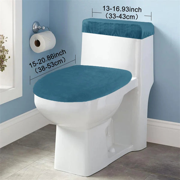 A white toilet seat with a teal velvet cushion and matching tank protectors mounted on a light blue wall.