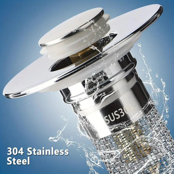A close-up of a stainless steel pop-up bathroom sink drain filter with a silver cap and mesh strainer, shown being used in wa