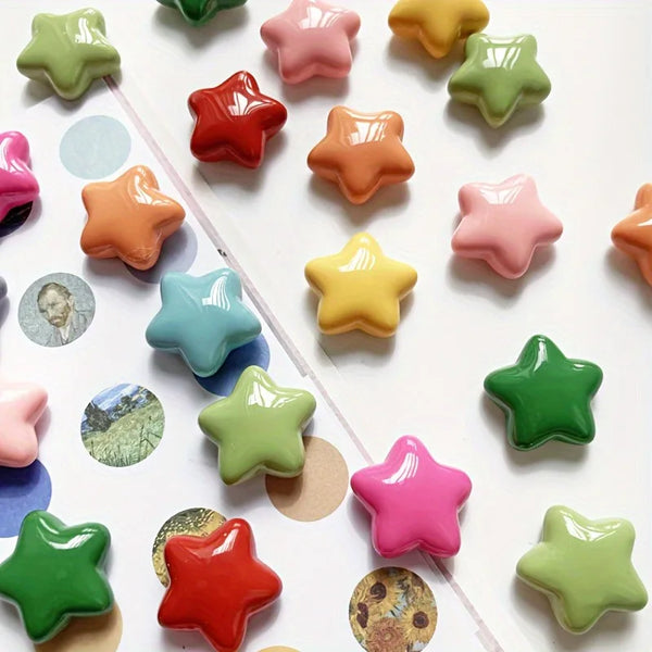 A collection of colorful, star-shaped refrigerator magnets in various shades of green, pink, orange, and yellow.