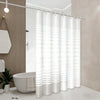 A white striped shower curtain hanging from a rod in a modern bathroom