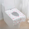 A white toilet seat covered with a pink flamingo patterned disposable printing seat cover.