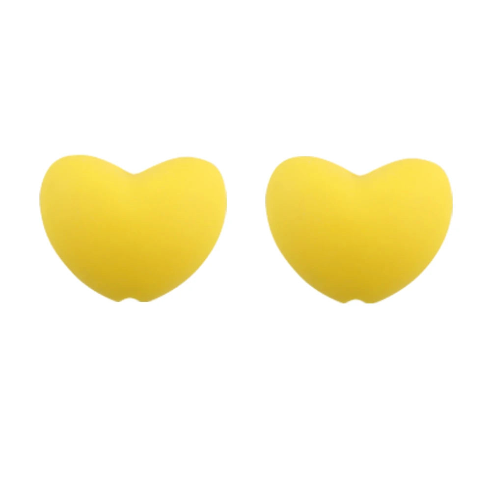 A pair of yellow heart-shaped silicone charm beads for DIY jewelry.