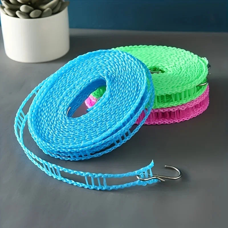 A stack of colorful heavy-duty portable clotheslines in blue, green, and pink are displayed on a gray surface.