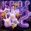 A set of purple and gold balloons shaped like guitars and stars for a party decoration.