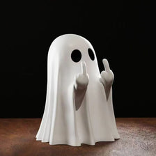 A white ghost statue decoration with raised fingers against a dark background.