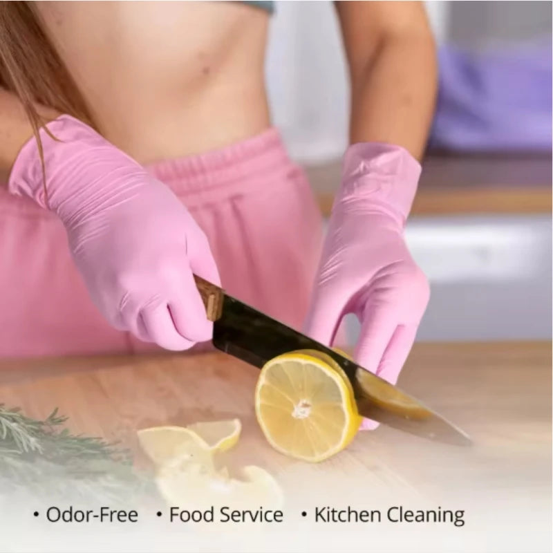 Pink disposable nitrile gloves are shown being used to cut a lemon for kitchen cleaning.
