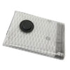 A clear vacuum compression travel bag with a black circular seal on top.