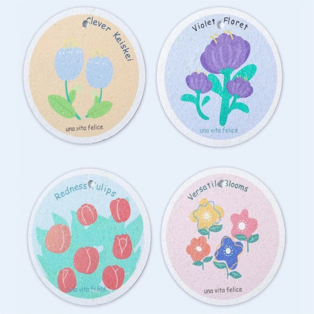 A pack of four natural cotton cleaning sponges with floral designs on a white background.