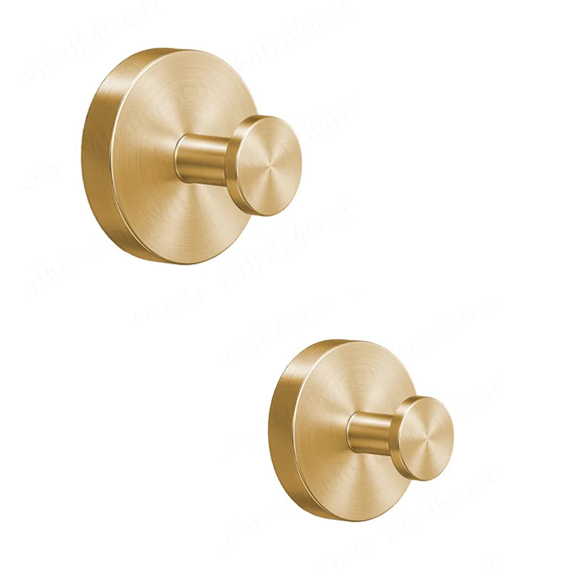 A round, brass-toned stainless steel suction cup towel rack with a protruding knob.