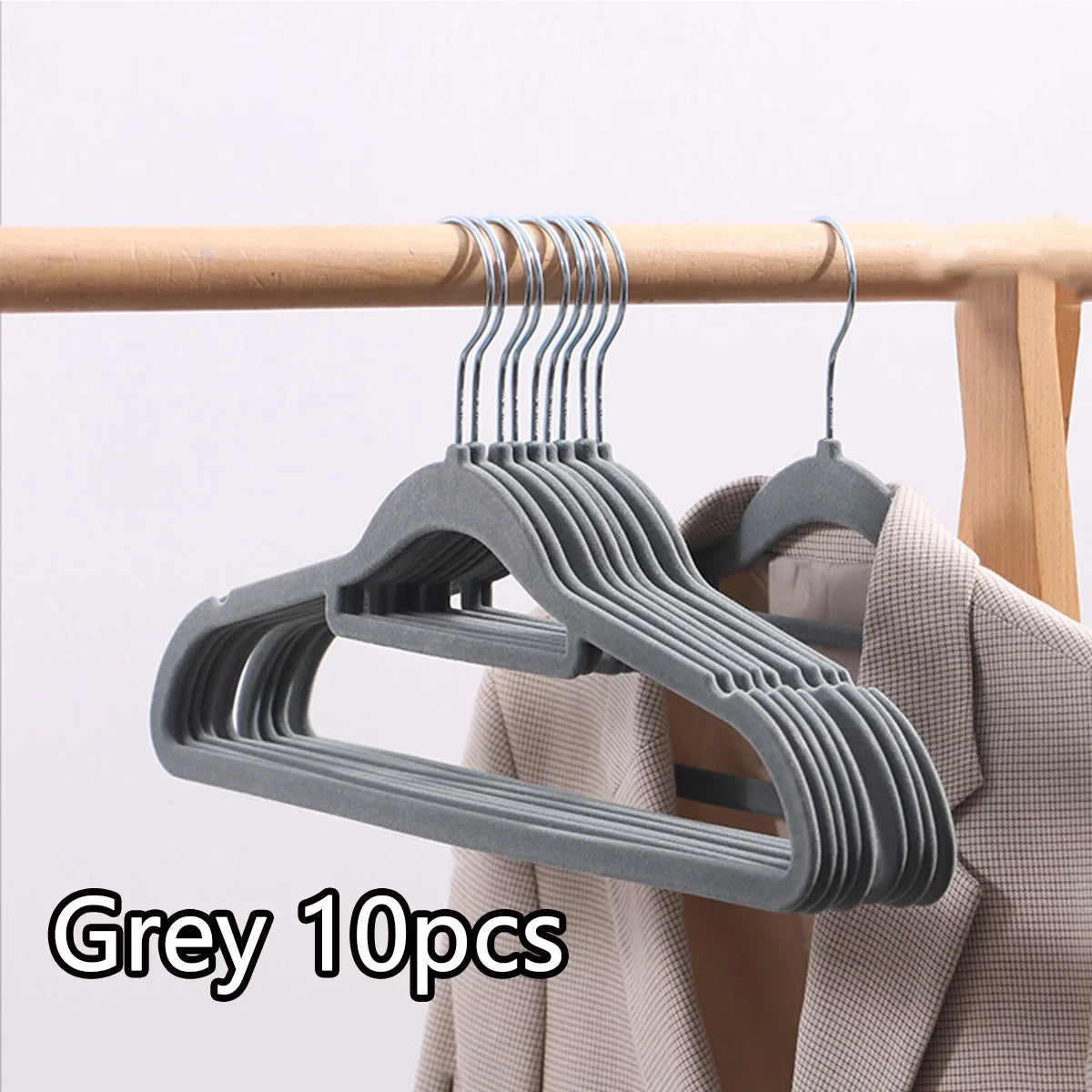 Grey velvet slim hangers set with 10 pieces hanging on a wooden rod