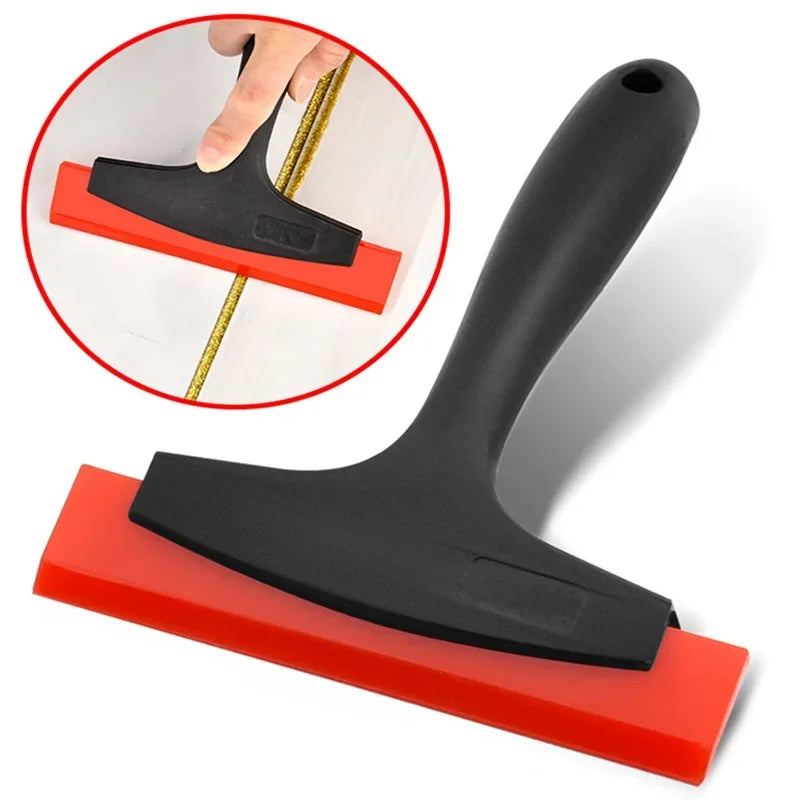 A black silicone scraper with a red handle is shown alongside an inset demonstrating its use for grout and gap filling.