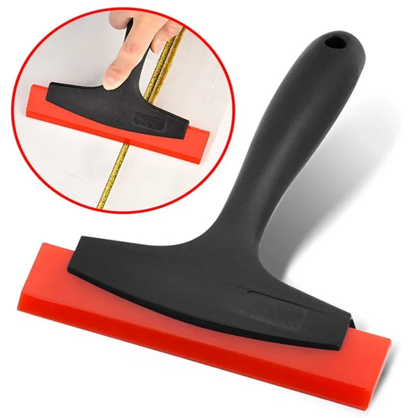 A black silicone scraper with a red handle is shown alongside an inset demonstrating its use for grout and gap filling.