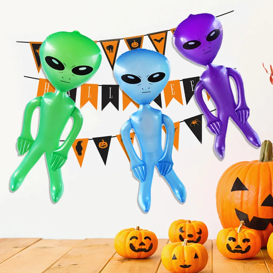 Three inflatable alien decorations in green, blue, and purple against a white background.