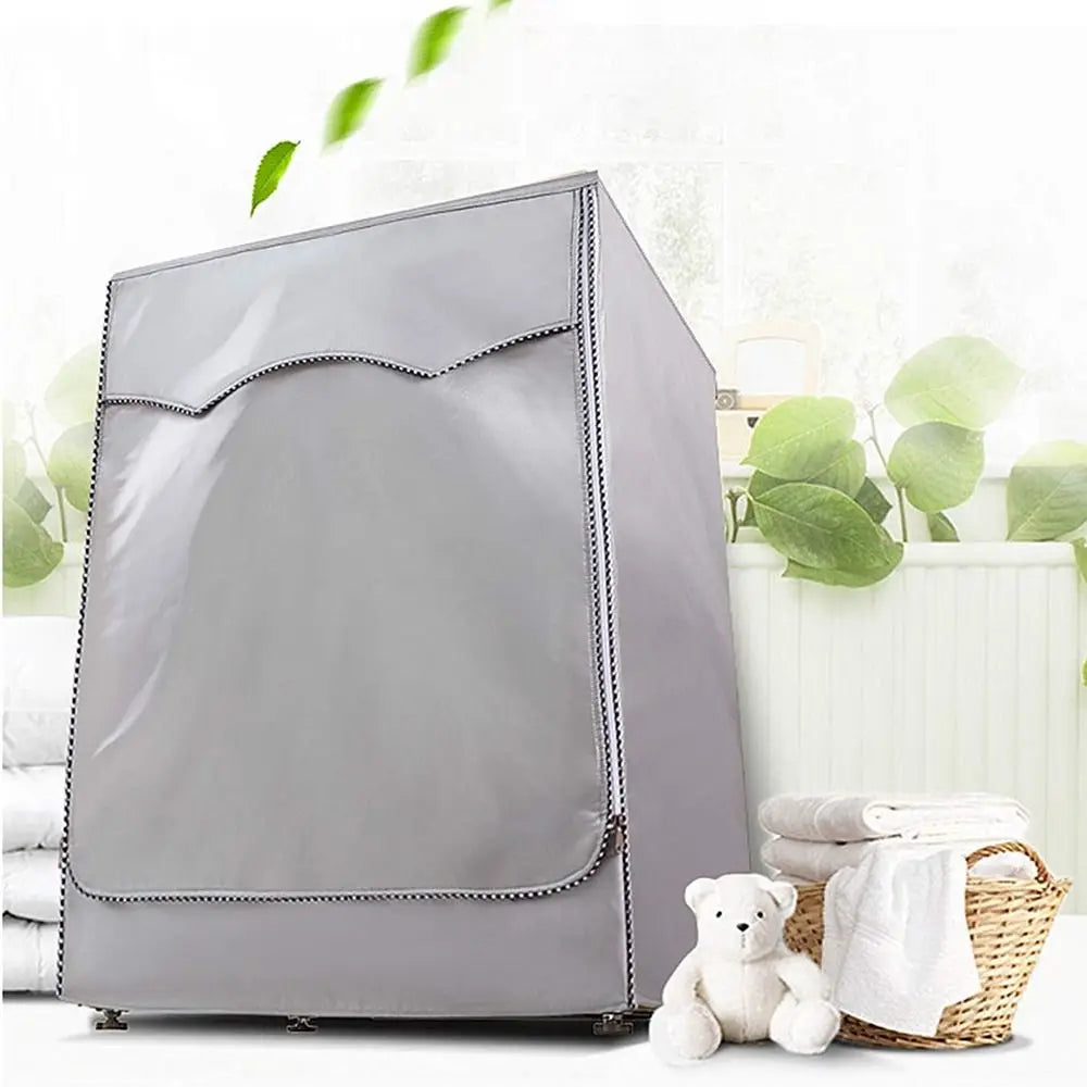 A silver Oxford washing machine cover with a roll edge is shown next to a stack of white towels and a woven basket.
