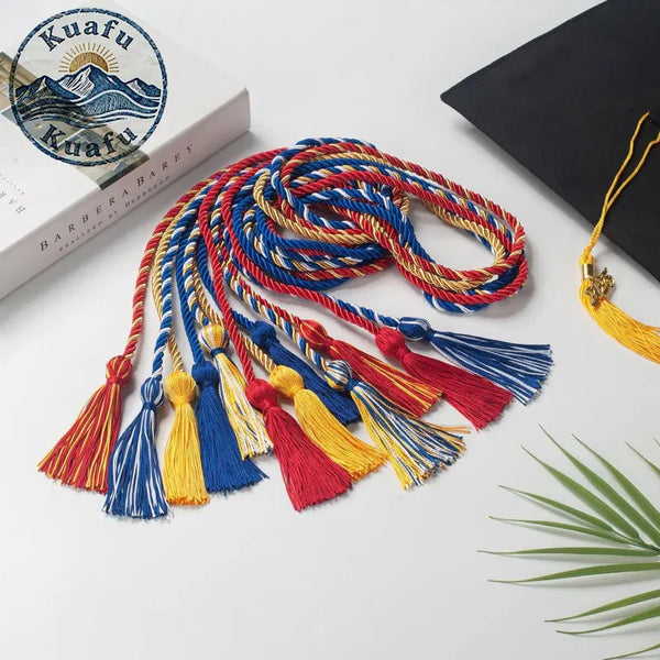 A bundle of graduation honor cords with colorful tassel ends in red, blue, and yellow on a white background.