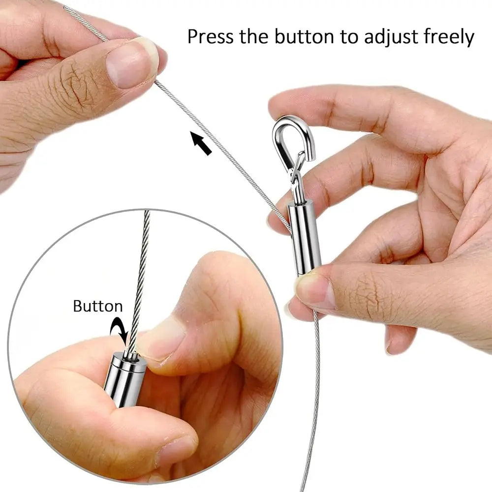 Hands are adjusting a stainless steel wire rope hanging kit by pressing a button to adjust the length.
