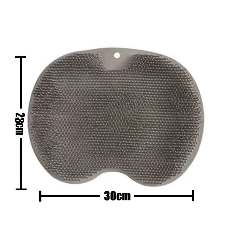 A gray reusable silicone foot scrub brush with a perforated surface and a hole for hanging.