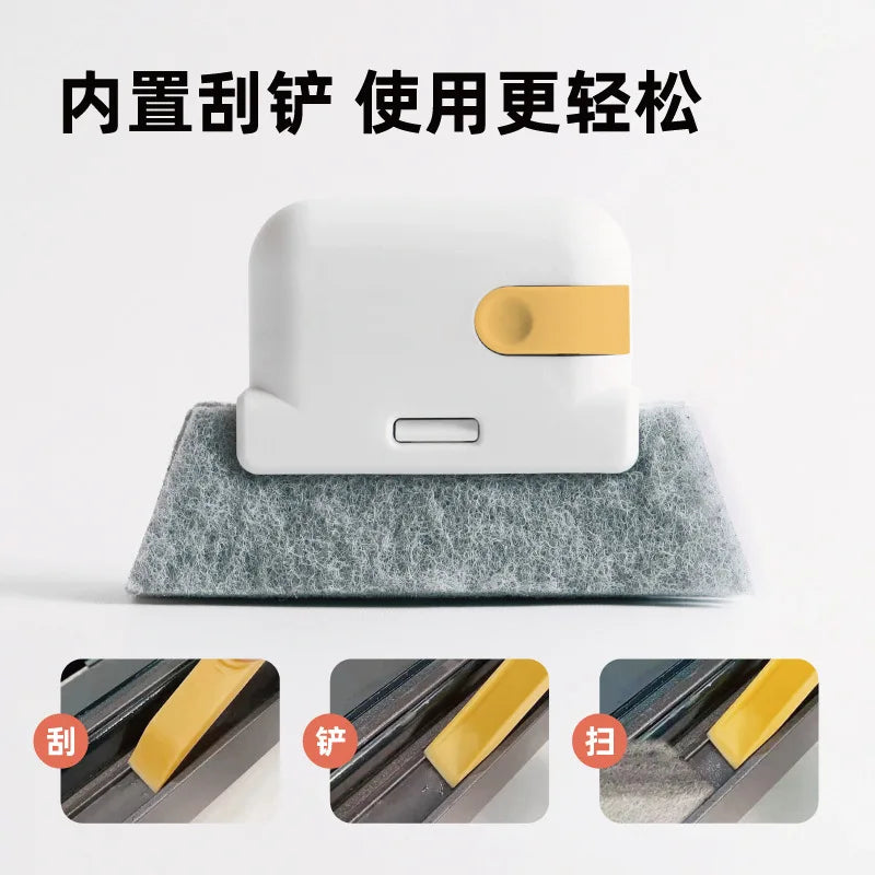 A white window and gap cleaning brush with a yellow handle resting on a gray foam surface.