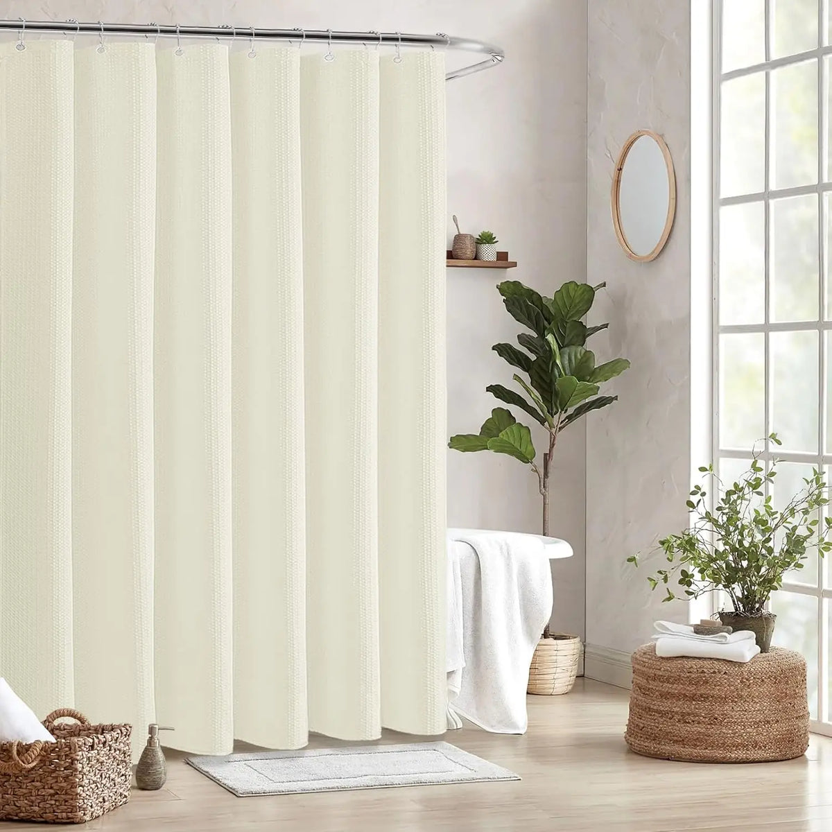 A cream-colored waffle weave shower curtain hanging on a metal rod in a bright bathroom setting.