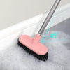 A pink heavy-duty long-handle floor scrub brush is shown scrubbing foam in a bathtub, demonstrating a 45-degree angle.
