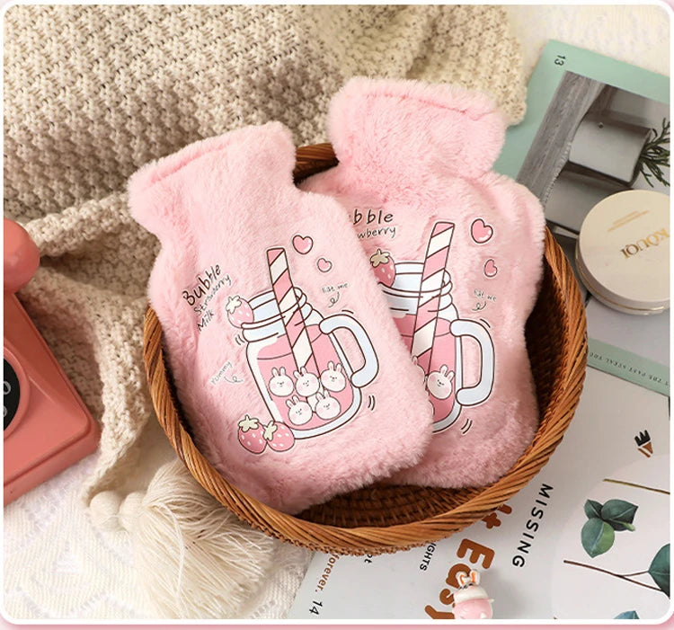 Pink plush cartoon hot water bottle featuring a striped drink design in a woven basket.