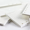 A close-up view of loose leaf notebook refill paper for spiral binders, showing white lined pages sealed in clear plastic.
