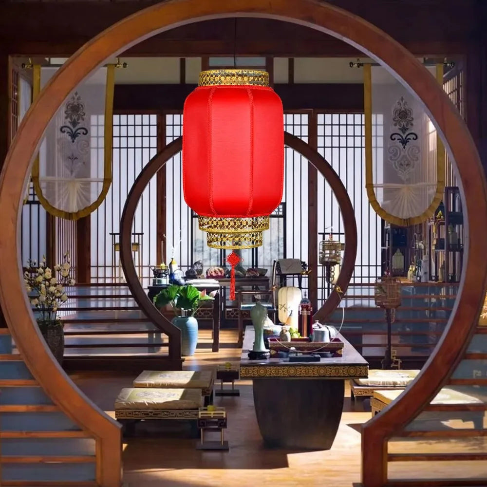 A durable antiqued red Chinese lantern hanging in a traditional wooden interior setting.