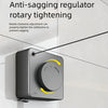 A close-up of an anti-sagging rotary tightening mechanism for a retractable wire clothesline mounted on a white wall.