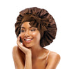 A woman wearing a brown satin sleeping cap tied in a bow, looking to the side.