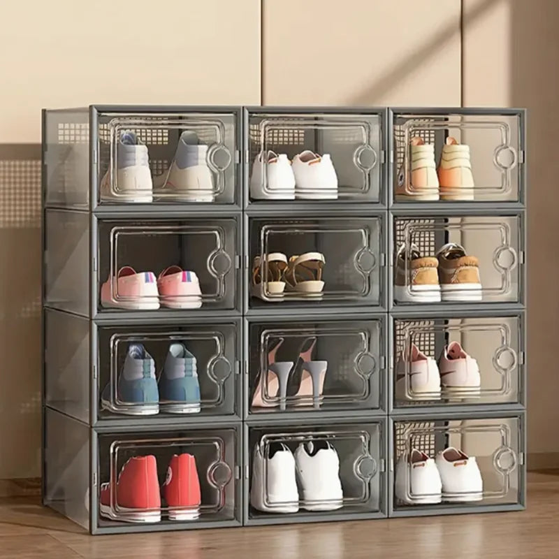 A set of twelve stackable transparent shoe storage boxes with various colored sneakers and boots.