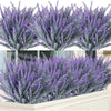 A close-up view of artificial lavender flowers in various shades of purple and gray.
