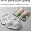 A collection of various colored bras and lingerie items are displayed on a gray surface.