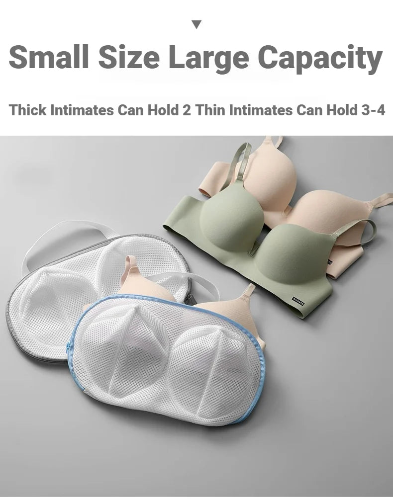 A collection of various colored bras and lingerie items are displayed on a gray surface.