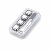 A clear plastic container holding several reusable stainless steel whiskey ice cubes and a small metal knife.