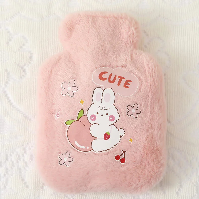 A pink plush cartoon hot water bottle featuring a cute white rabbit and an apple.