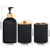 A set of black and wood bathroom countertop organizers featuring a pump dispenser bottle and cylindrical containers.