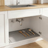 A silicone under sink waterproof mat is placed inside a white kitchen cabinet for protection.