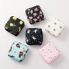 A collection of various floral nylon sanitary pad storage pouches in black, pink, and light green.