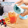 Hands gently press an ice cube mold to release ice into a glass of juice.