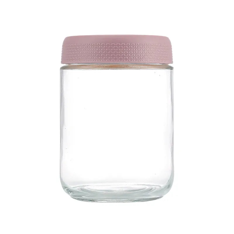 A clear glass meal prep jar with a light pink airtight lid.
