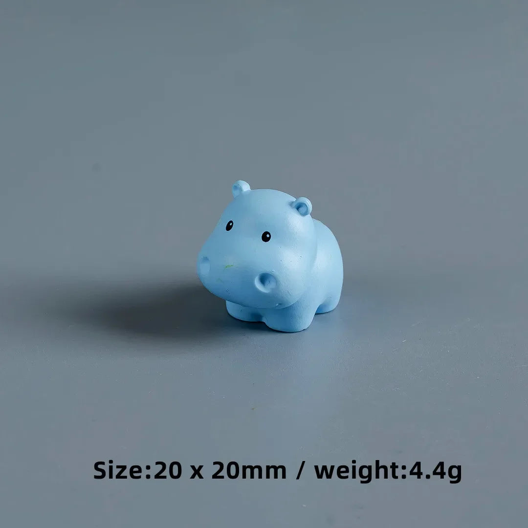 A small, light blue resin figurine shaped like a baby elephant.