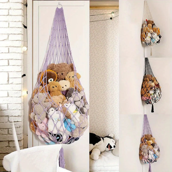 Macrame stuffed animal storage hammock hanging on a white door frame