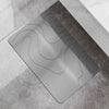 A gray bathroom mat with a wavy texture is placed on a marble floor.