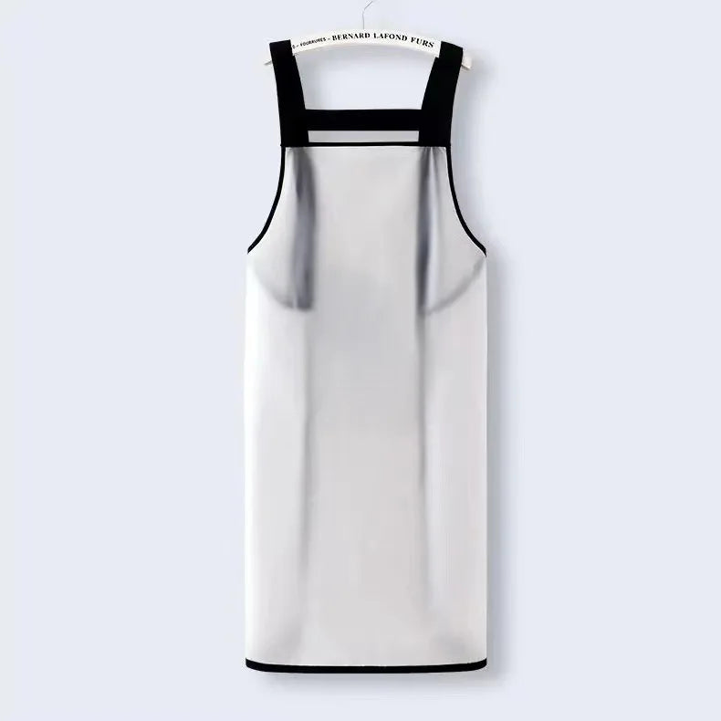A white waterproof transparent kitchen apron with black straps hanging against a light gray background.