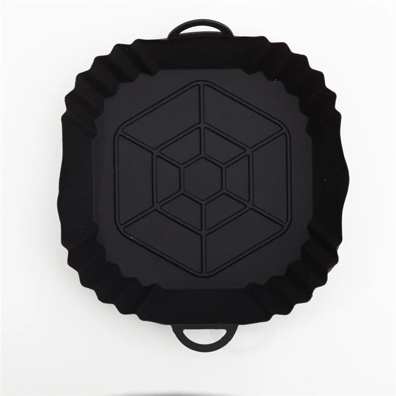 Black reusable silicone air fryer liner with a fluted edge and a hexagonal pattern.